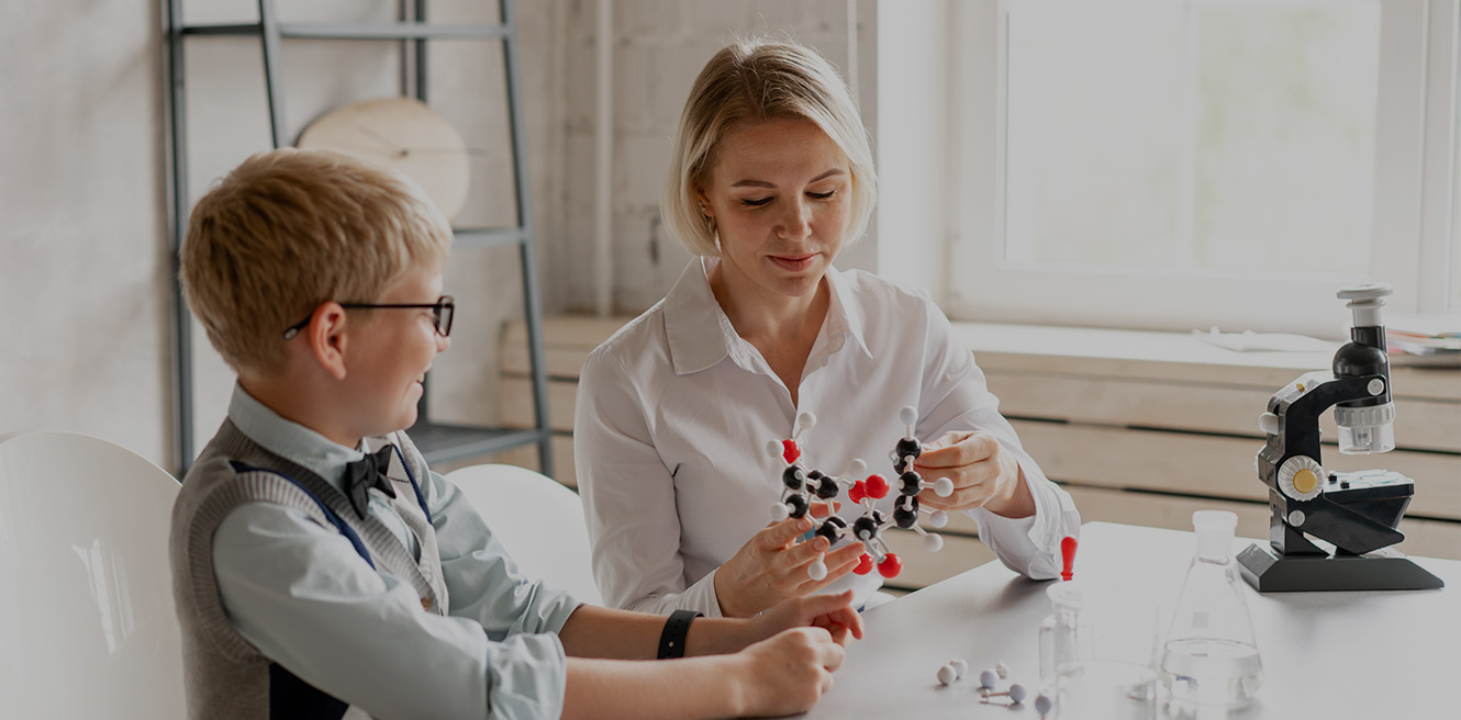 Female science tutor in St Petersburg studying chemistry with student